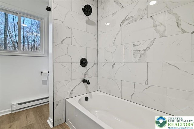 182 Maxatawny Dr, Coolbaugh Twp, PA 18347 - full bathroom featuring a baseboard radiator, wood finished floors, and shower / bath combination
