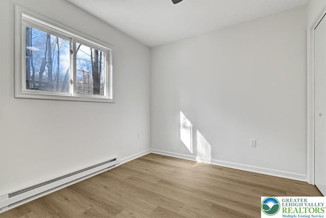 182 Maxatawny Dr, Coolbaugh Twp, PA 18347 - spare room featuring a baseboard heating unit, wood finished floors, and ceiling fan