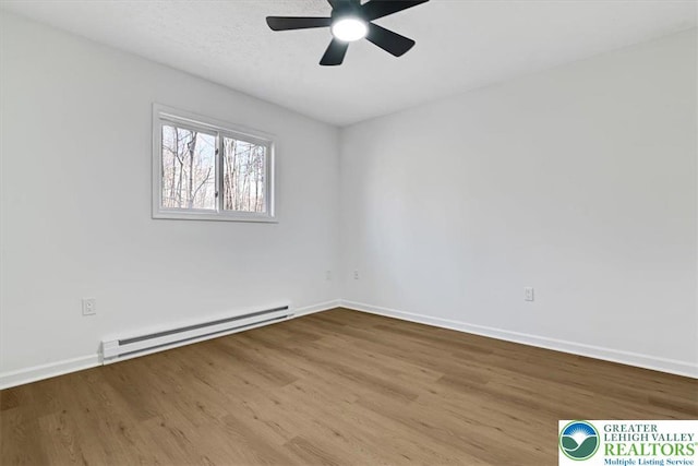 182 Maxatawny Dr, Coolbaugh Twp, PA 18347 - empty room with a baseboard radiator, wood finished floors, and ceiling fan