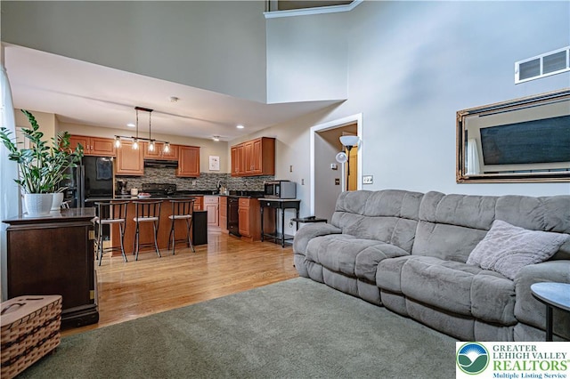 2877 Hope Ridge Dr, Bethlehem Twp, PA 18045 - living room with light wood-style flooring, a high ceiling, and recessed lighting