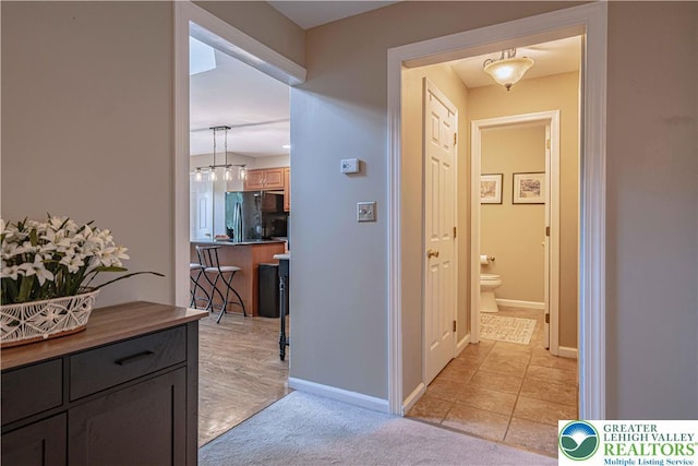 2877 Hope Ridge Dr, Bethlehem Twp, PA 18045 - corridor featuring light colored carpet and a chandelier