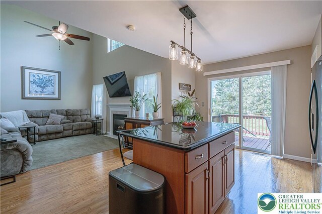 2877 Hope Ridge Dr, Bethlehem Twp, PA 18045 - kitchen featuring a ceiling fan, open floor plan, light wood finished floors, and brown cabinetry