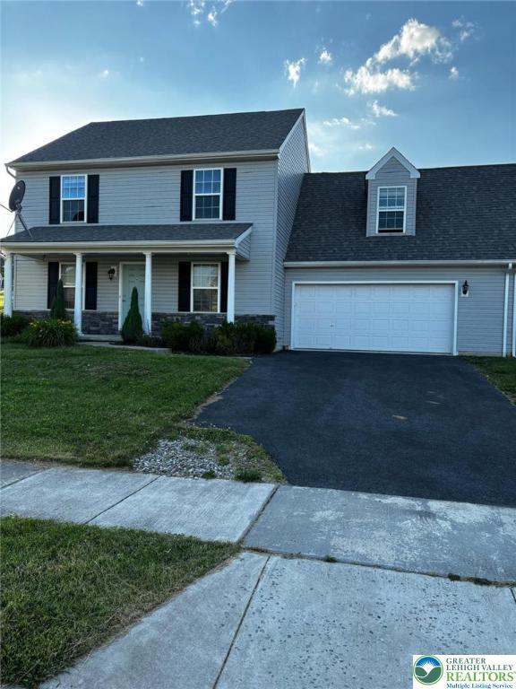 4954 Coatbridge Ln, Lehigh Twp, PA 18088 - view of front of house with asphalt driveway, a front yard, a garage, and a porch