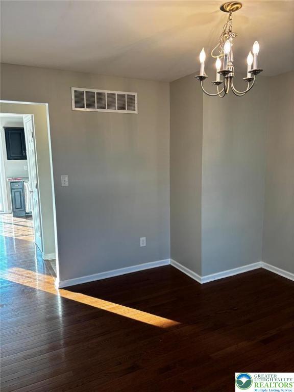 4954 Coatbridge Ln, Lehigh Twp, PA 18088 - empty room featuring a chandelier and wood finished floors