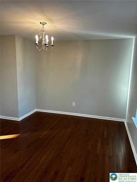 4954 Coatbridge Ln, Lehigh Twp, PA 18088 - unfurnished room with dark wood-style floors and a chandelier