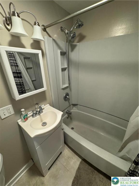 449 E Garrison St, Bethlehem City, PA 18018 - bathroom featuring shower / bath combo with shower curtain, vanity, and tile patterned flooring