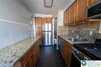 449 E Garrison St, Bethlehem City, PA 18018 - kitchen featuring stainless steel appliances, brown cabinets, light stone counters, backsplash, and dark wood finished floors