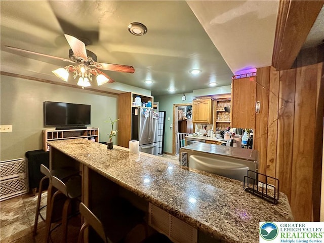 189 W 27th St, Northampton Boro, PA 18067 - kitchen with freestanding refrigerator, open shelves, a ceiling fan, brown cabinets, and a kitchen bar