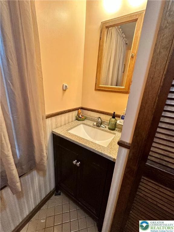 189 W 27th St, Northampton Boro, PA 18067 - bathroom with vanity, wainscoting, and tile patterned flooring