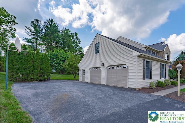 2029 Amherst Dr, Lower Saucon Twp, PA 18015 - view of side of home with asphalt driveway and a garage