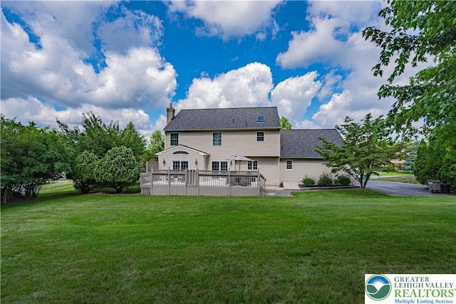 2029 Amherst Dr, Lower Saucon Twp, PA 18015 - back of house featuring a deck, a chimney, and a lawn