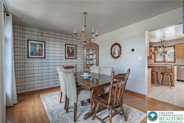 2029 Amherst Dr, Lower Saucon Twp, PA 18015 - dining room with a chandelier, wallpapered walls, an accent wall, and light wood-type flooring