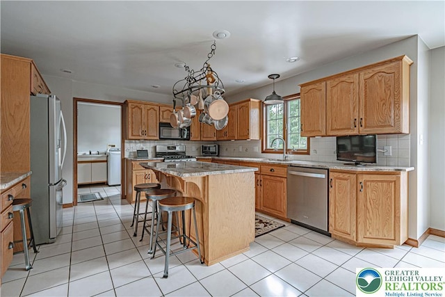 2029 Amherst Dr, Lower Saucon Twp, PA 18015 - kitchen with stainless steel appliances, a kitchen island, decorative backsplash, a kitchen breakfast bar, and recessed lighting