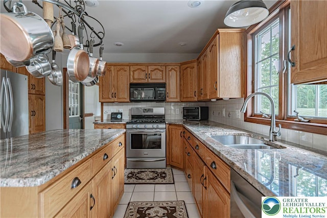 2029 Amherst Dr, Lower Saucon Twp, PA 18015 - kitchen featuring stainless steel appliances, light tile patterned flooring, decorative backsplash, and light stone counters