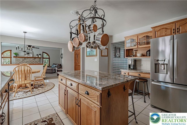 2029 Amherst Dr, Lower Saucon Twp, PA 18015 - kitchen featuring stainless steel fridge with ice dispenser, a chandelier, light tile patterned floors, a center island, and a breakfast bar