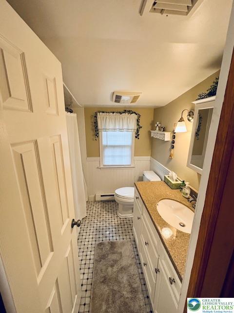 2734 Old Bethlehem Pike, Milford Twp, PA 18951 - bathroom with vanity, wainscoting, curtained shower, tile patterned flooring, and a baseboard radiator
