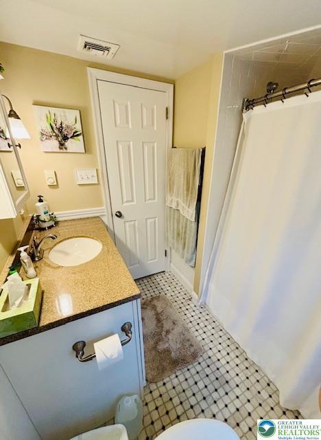 2734 Old Bethlehem Pike, Milford Twp, PA 18951 - bathroom with vanity, a shower with curtain, and tile patterned flooring