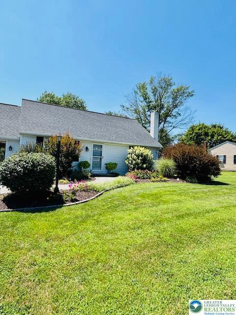 2734 Old Bethlehem Pike, Milford Twp, PA 18951 - view of side of home with a lawn and a chimney
