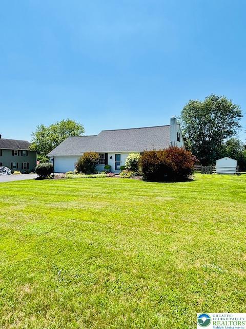 2734 Old Bethlehem Pike, Milford Twp, PA 18951 - view of front of property featuring an attached garage and a front yard