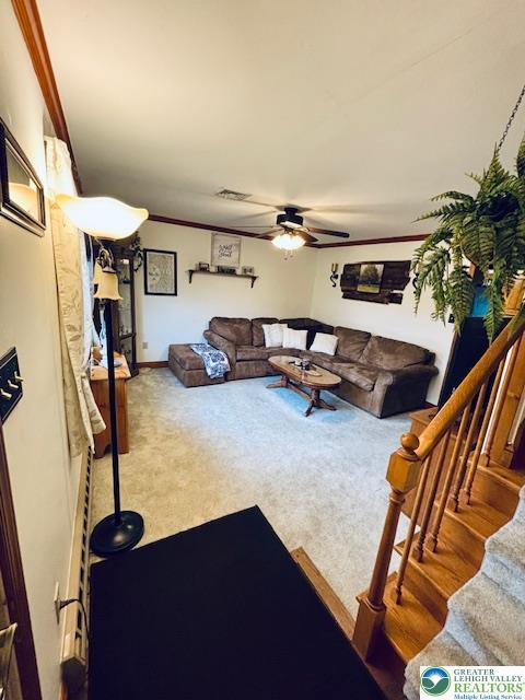 2734 Old Bethlehem Pike, Milford Twp, PA 18951 - living room with carpet floors, a ceiling fan, stairway, and crown molding