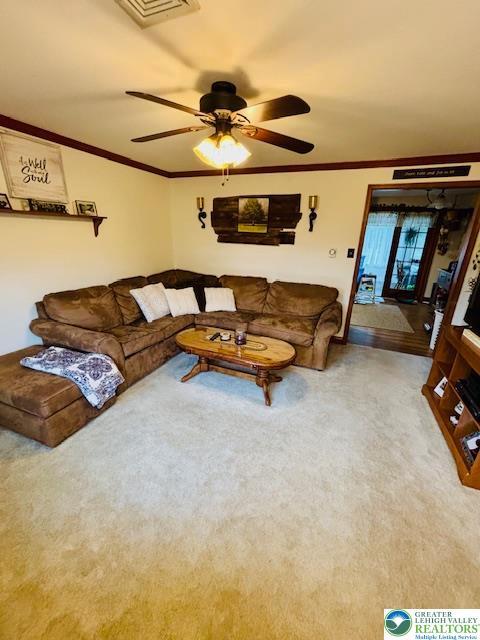 2734 Old Bethlehem Pike, Milford Twp, PA 18951 - living area with a ceiling fan, crown molding, and carpet floors