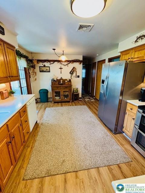 2734 Old Bethlehem Pike, Milford Twp, PA 18951 - kitchen featuring appliances with stainless steel finishes, light wood finished floors, light countertops, and brown cabinetry