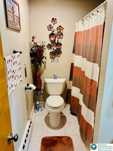 2734 Old Bethlehem Pike, Milford Twp, PA 18951 - bathroom with a baseboard heating unit, tile patterned floors, and a shower with shower curtain