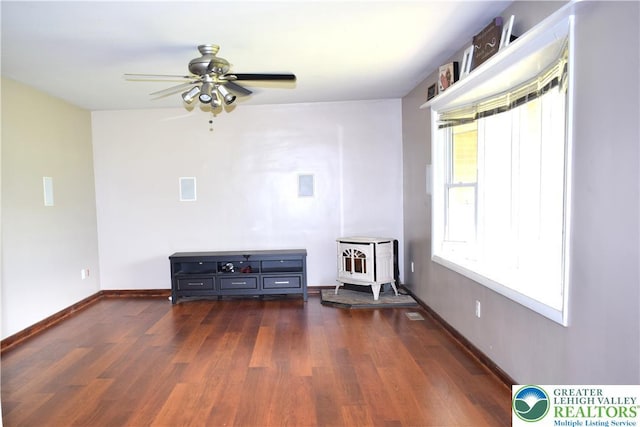 2841 Willow St, North Whitehall Twp, PA 18037 - living area featuring a wood stove, wood finished floors, and ceiling fan