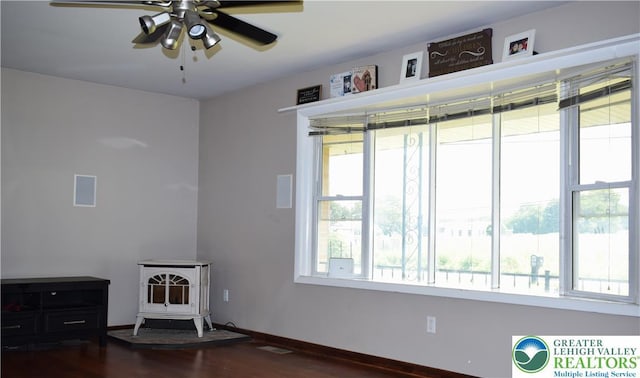 2841 Willow St, North Whitehall Twp, PA 18037 - unfurnished room with a wood stove, dark wood finished floors, and a ceiling fan