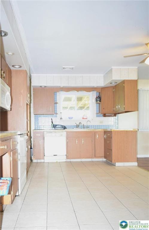 2841 Willow St, North Whitehall Twp, PA 18037 - kitchen featuring white appliances, backsplash, light tile patterned floors, a ceiling fan, and light countertops