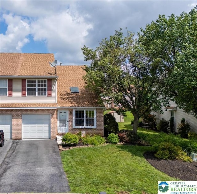 2721 Victoria Ln, Easton, PA 18045 - multi unit property with a front yard, asphalt driveway, brick siding, and an attached garage