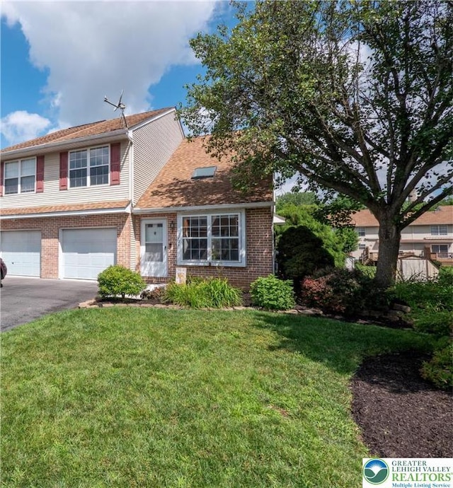2721 Victoria Ln, Easton, PA 18045 - view of front of house featuring a garage, brick siding, asphalt driveway, and a front lawn