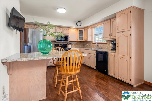 2721 Victoria Ln, Easton, PA 18045 - kitchen with black appliances, dark wood finished floors, a breakfast bar area, backsplash, and glass insert cabinets
