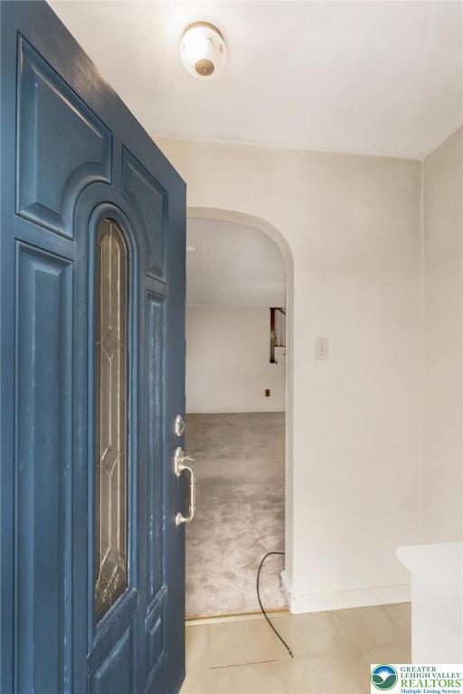 457 E Lawn Rd, Upper Nazareth Twp, PA 18064 - carpeted foyer entrance with arched walkways and tile patterned floors