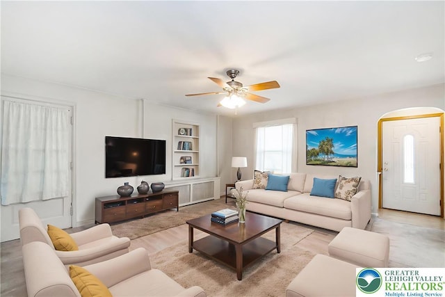 457 E Lawn Rd, Upper Nazareth Twp, PA 18064 - living room with arched walkways, a ceiling fan, built in features, and wood finished floors