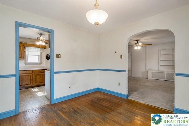 457 E Lawn Rd, Upper Nazareth Twp, PA 18064 - unfurnished room with a ceiling fan, arched walkways, wood finished floors, and built in shelves