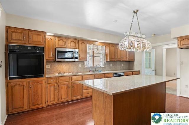 242 Schoeneck Ave, Nazareth Boro, PA 18064 - kitchen with black appliances, dark wood-type flooring, light stone counters, tasteful backsplash, and brown cabinetry