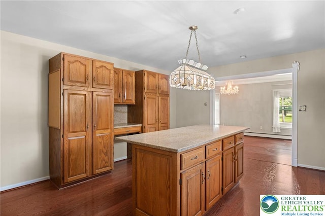 242 Schoeneck Ave, Nazareth Boro, PA 18064 - kitchen with a baseboard heating unit, dark wood finished floors, a center island, pendant lighting, and light stone countertops