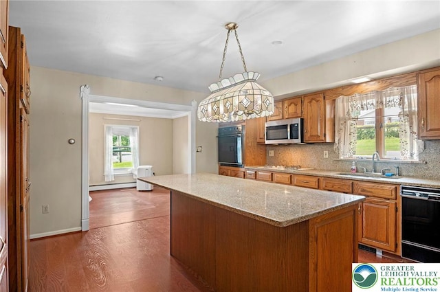 242 Schoeneck Ave, Nazareth Boro, PA 18064 - kitchen with black appliances, a center island, backsplash, and brown cabinets