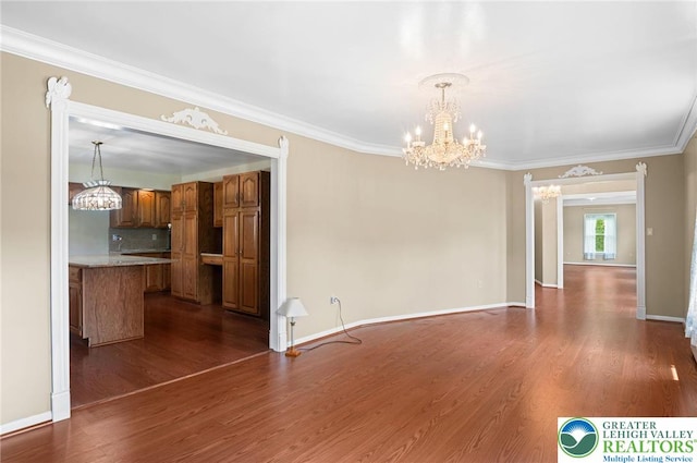 242 Schoeneck Ave, Nazareth Boro, PA 18064 - unfurnished living room featuring a chandelier, dark wood finished floors, and crown molding