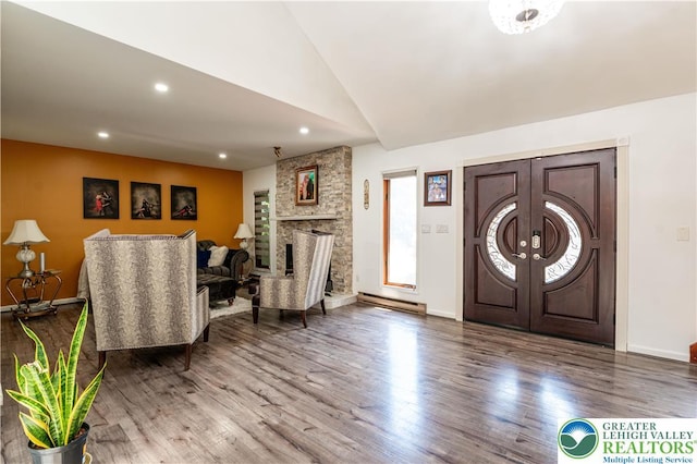 1555 Longleaf Dr, Chestnuthill Twp, PA 18330 - entrance foyer featuring lofted ceiling, wood finished floors, recessed lighting, a stone fireplace, and french doors