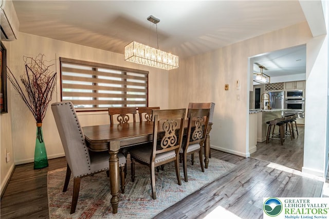 1555 Longleaf Dr, Chestnuthill Twp, PA 18330 - dining room featuring a chandelier, a wall mounted air conditioner, and wood finished floors