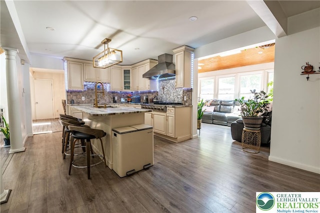 1555 Longleaf Dr, Chestnuthill Twp, PA 18330 - kitchen featuring cream cabinets, wall chimney range hood, and stainless steel gas cooktop