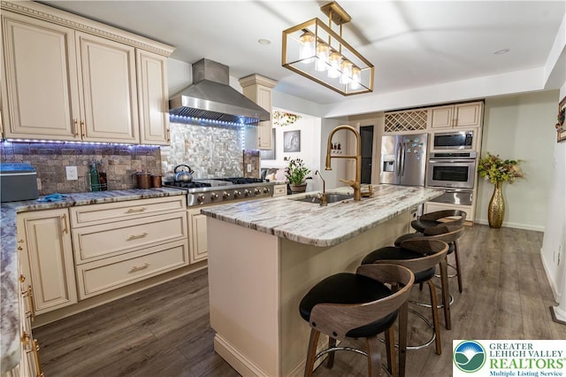 1555 Longleaf Dr, Chestnuthill Twp, PA 18330 - kitchen featuring cream cabinetry, wall chimney exhaust hood, appliances with stainless steel finishes, and a warming drawer