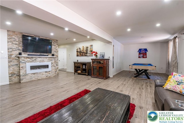 1555 Longleaf Dr, Chestnuthill Twp, PA 18330 - living room featuring wood finished floors, a stone fireplace, and recessed lighting