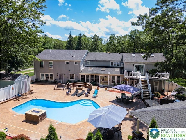 1555 Longleaf Dr, Chestnuthill Twp, PA 18330 - view of swimming pool with a fire pit, a jacuzzi, a fenced backyard, a wooden deck, and a patio