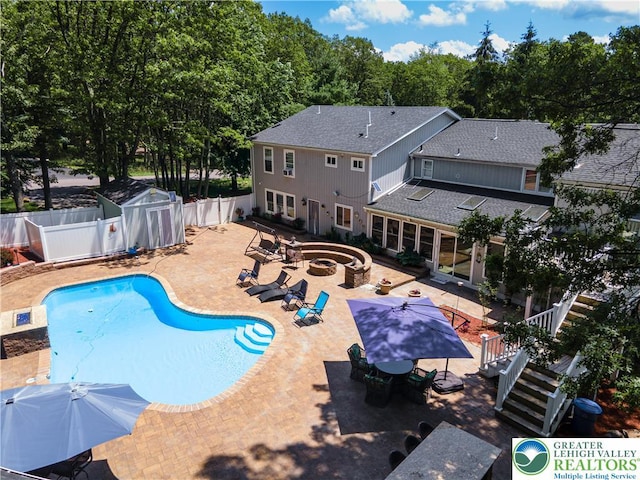 1555 Longleaf Dr, Chestnuthill Twp, PA 18330 - view of pool with an outdoor fire pit, a fenced backyard, a patio area, and outdoor dining space