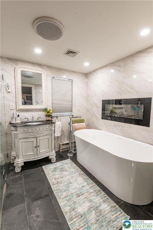 1555 Longleaf Dr, Chestnuthill Twp, PA 18330 - full bath with vanity, a freestanding tub, and tile walls