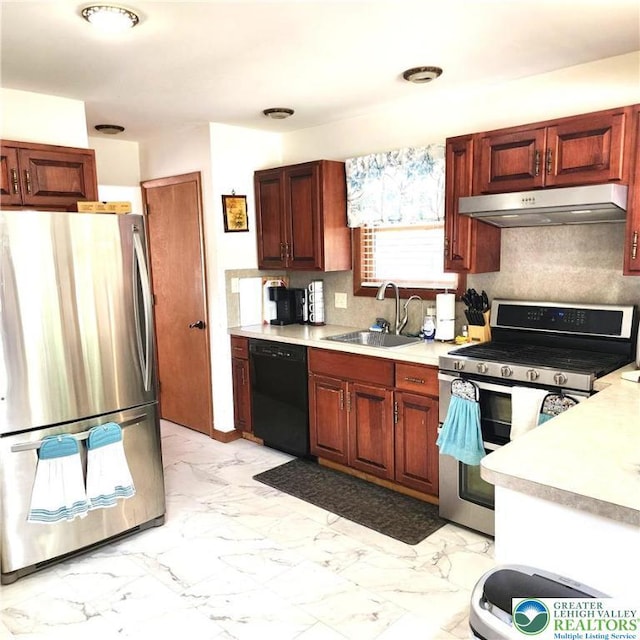 408 Sassafrass Way, Jackson Twp, PA 18360 - kitchen with appliances with stainless steel finishes, under cabinet range hood, light countertops, light marble finish flooring, and tasteful backsplash