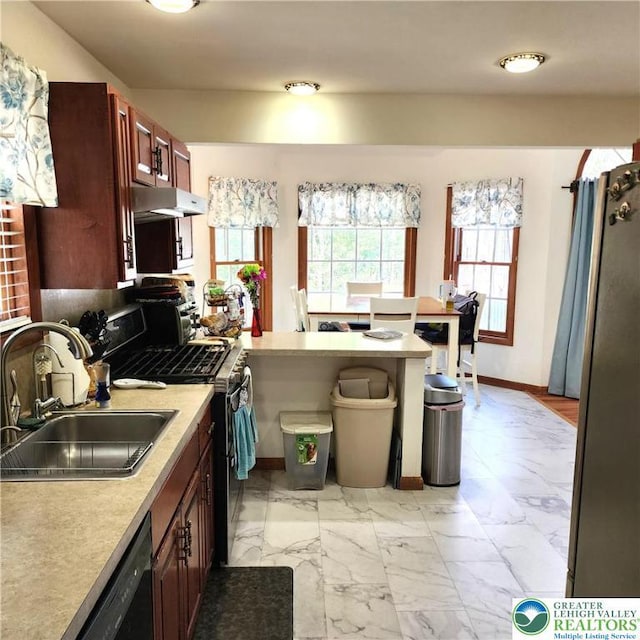 408 Sassafrass Way, Jackson Twp, PA 18360 - kitchen with stainless steel appliances, light marble finish flooring, light countertops, a peninsula, and under cabinet range hood